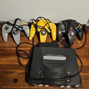 Nintendo 64 Console with Black, Gray, and Yellow Controllers READ DESCRIPTION